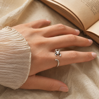 The Storybook Mouse Ring worn beside an open book