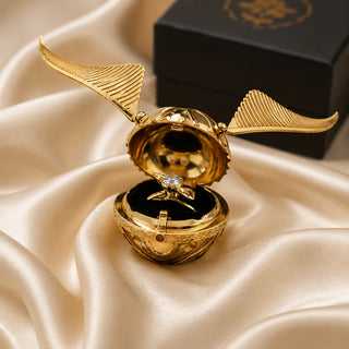 Mechanical Golden Snitch opened to reveal adjustable ring