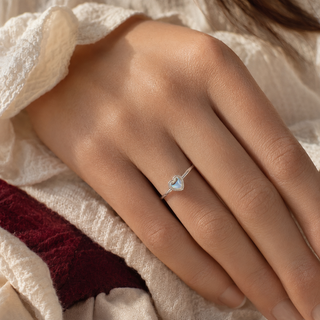 The Afterglow Heart Ring worn on the hand