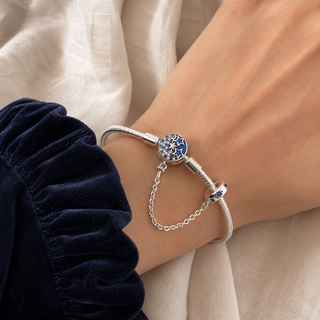 The Celestial Keeper Charm Bracelet worn on wrist