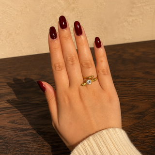 Adjustable Golden Snitch ring worn on hand in a direct-flash jewellery photoshoot