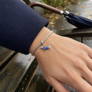 The Little Blue Jumper Dachshund Charm worn on a silver charm bracelet