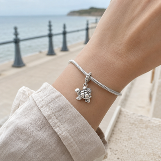 Long Way Home turtle charm worn at realistic scale