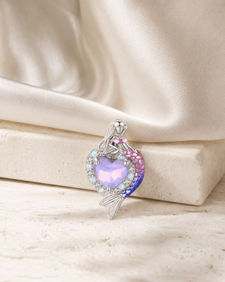 The Mermaid Heart Charm story image on ivory silk and pale stone