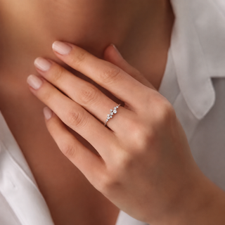Silver Moissanite ring worn on hand in soft lifestyle jewellery photography