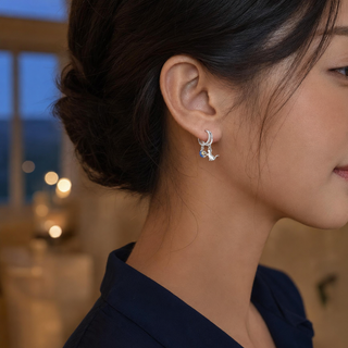 The Moonlit Cat Earrings worn on the ear