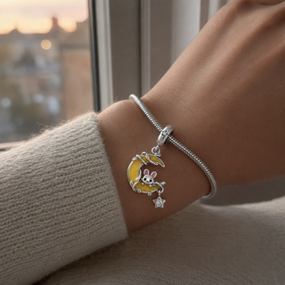 Moonlit Wish Bunny Charm worn at realistic scale on a silver charm bracelet