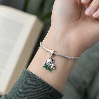 The Quiet Grove Koala Charm worn at true scale on a silver charm bracelet