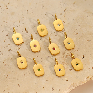 Rectangle birthstone pendants on pale stone surface