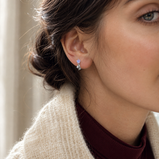 The Starlit Mischief Cat Earrings worn on the ear