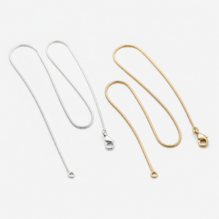 The Story Chain Necklace in silver and gold on a clean f5 background