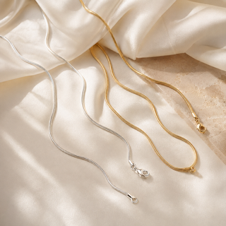 Silver and gold 2 mm necklace chains on ivory silk and pale stone