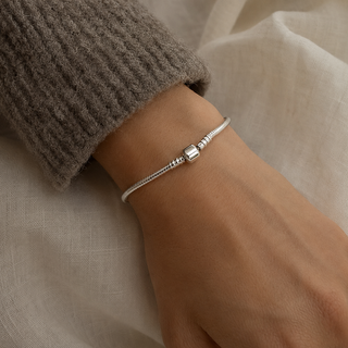The Storykeeper Charm Bracelet worn on wrist