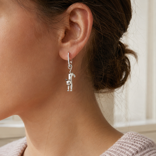 The Sunday Stretch Cat Earrings worn on the ear
