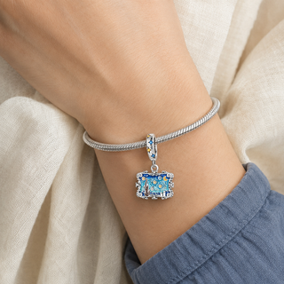 The Midnight Gallery Charm worn on a silver charm bracelet