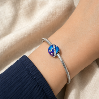 The Orbiting Moon Charm worn on a silver charm bracelet