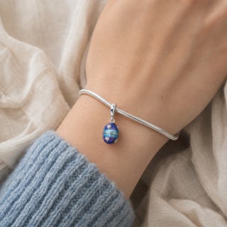 The Starlight Keepsake Charm worn on a silver charm bracelet
