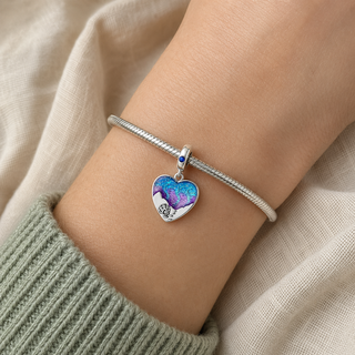 The Wildest Dreams Heart Charm worn on a silver charm bracelet