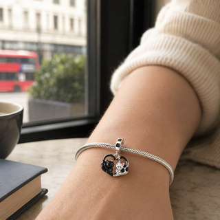 Two Souls Cat charm worn on a silver bracelet at true scale